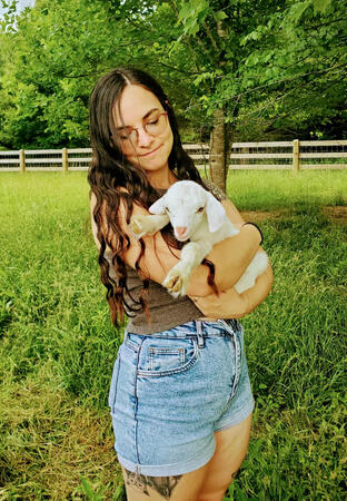 Bee w/ kid (baby goat) at ecovillage we lived at